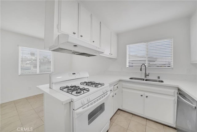 kitchen with under cabinet range hood, light countertops, white range with gas cooktop, stainless steel dishwasher, and a sink