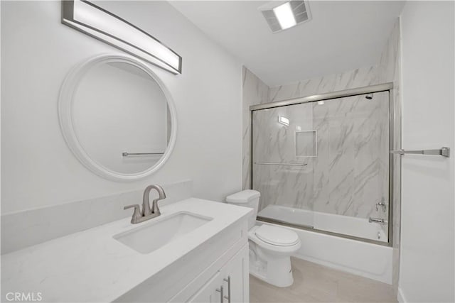 bathroom featuring visible vents, enclosed tub / shower combo, toilet, and vanity