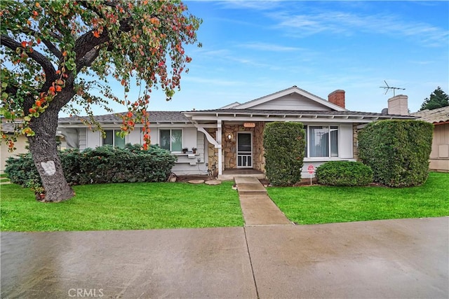 ranch-style home with a front lawn and a chimney