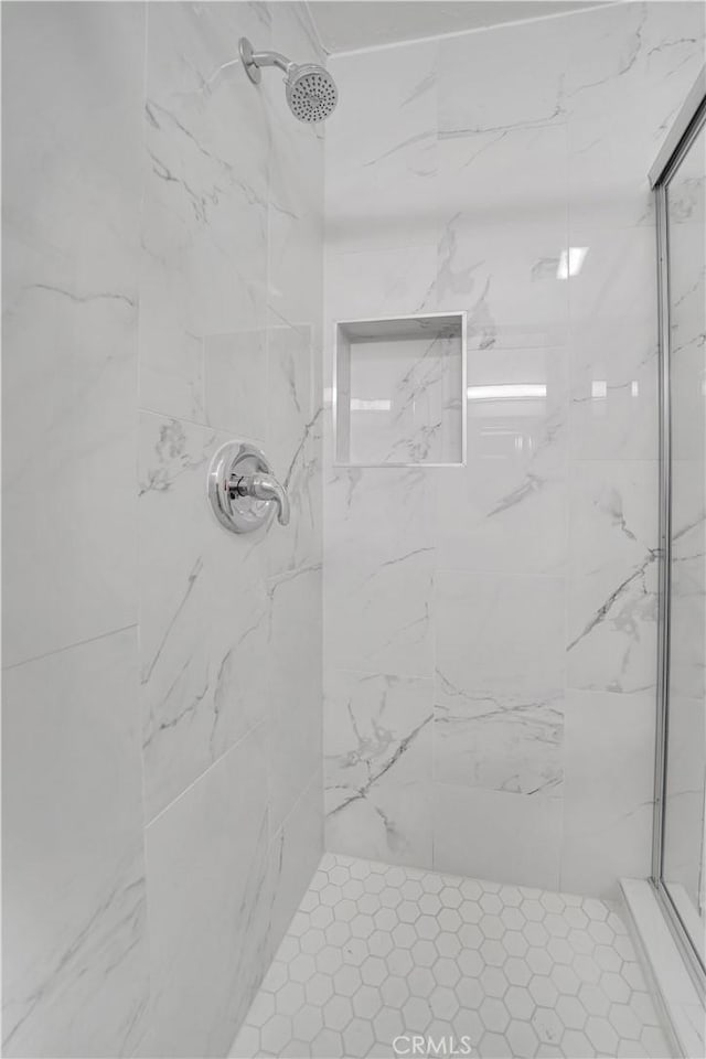 full bath featuring a marble finish shower