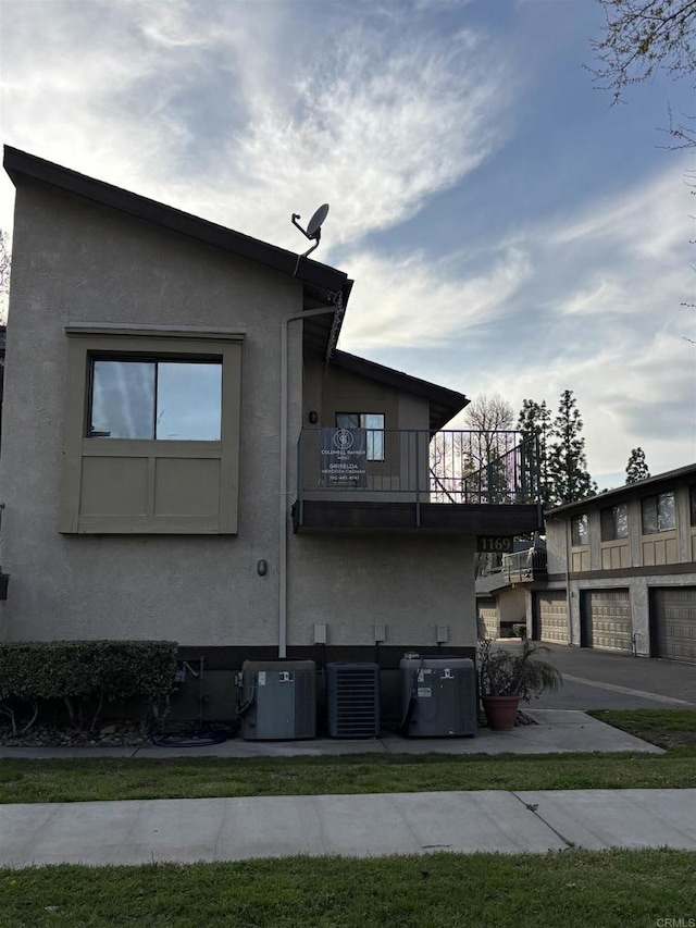 1169EAST Cornell Ave Unit 52, Redlands, CA 92374 - view of side of property with stucco siding, central AC unit, and a balcony