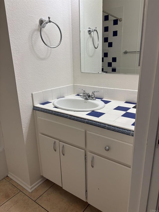 1169EAST Cornell Ave Unit 52, Redlands, CA 92374 - bathroom with tile patterned floors, vanity, decorative backsplash, and walk in shower