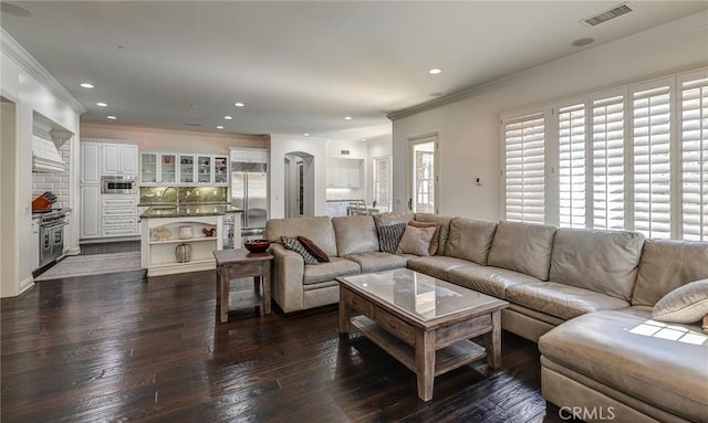 4 Andromeda Isle, Ladera Ranch, CA 92694 - living area featuring ornamental molding, recessed lighting, dark wood finished floors, and arched walkways