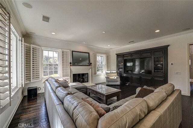 living room with visible vents, dark wood-style floors, and a healthy amount of sunlight