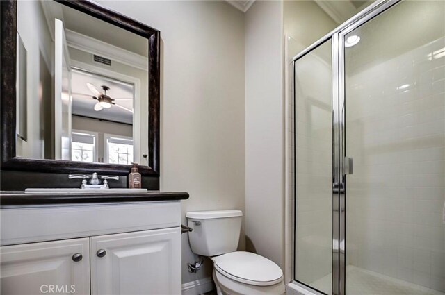 bathroom with a shower stall, ornamental molding, and toilet