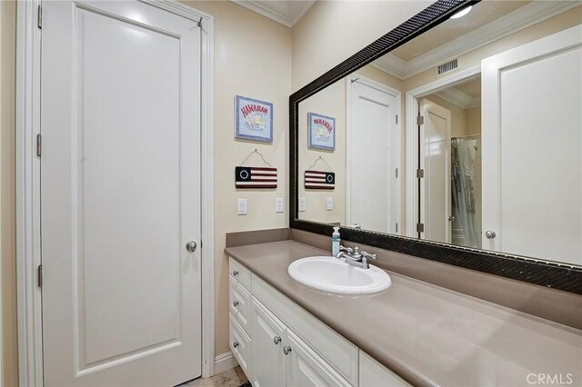full bath with crown molding, vanity, and visible vents