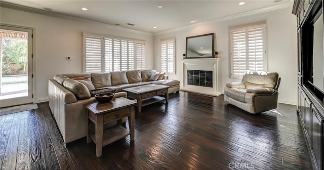 4 Andromeda Isle, Ladera Ranch, CA 92694 - living room featuring crown molding, a glass covered fireplace, dark wood-style flooring, and recessed lighting