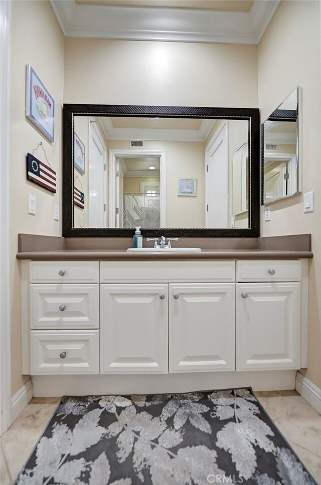 4 Andromeda Isle, Ladera Ranch, CA 92694 - bathroom with crown molding, baseboards, vanity, and marble finish flooring