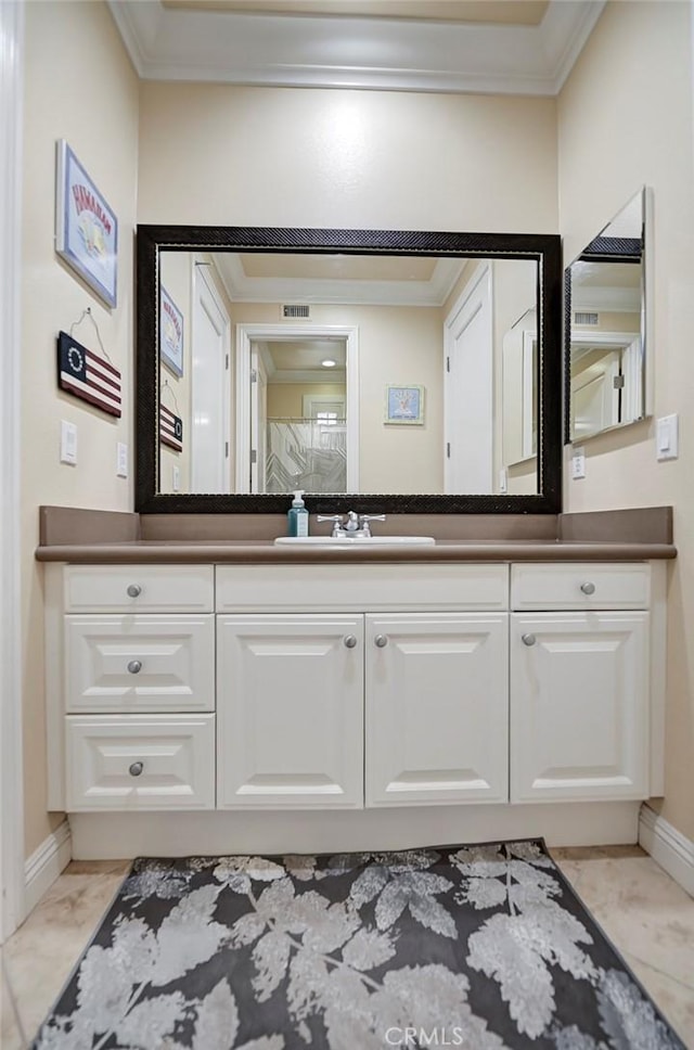 4 Andromeda Isle, Ladera Ranch, CA 92694 - bathroom featuring ornamental molding, vanity, and marble look tile flooring