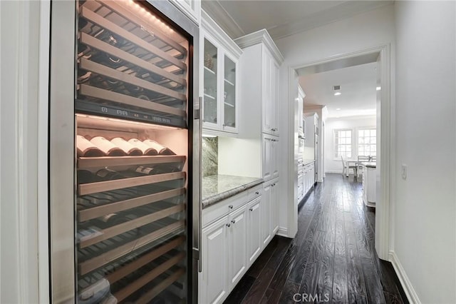 4 Andromeda Isle, Ladera Ranch, CA 92694 - wine cellar featuring beverage cooler, crown molding, dark wood-type flooring, and baseboards