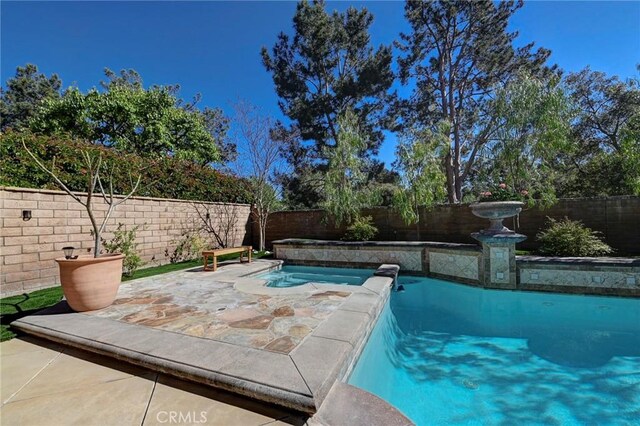 view of swimming pool with a fenced backyard, a patio, and a fenced in pool