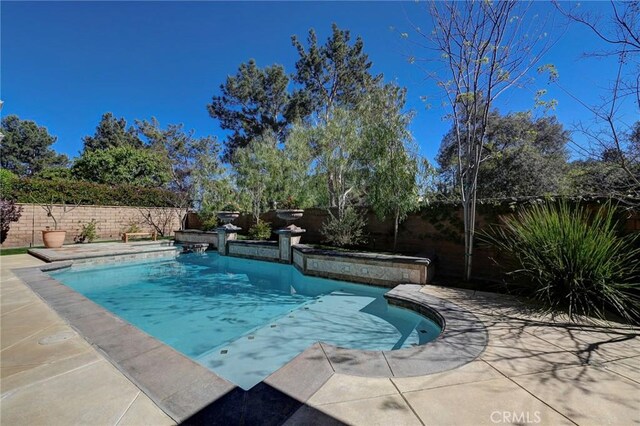 view of swimming pool featuring a fenced backyard, a patio area, and a fenced in pool