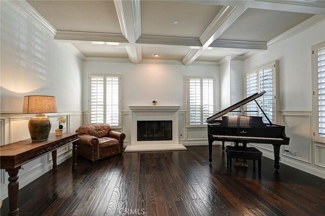 sitting room with wood-type flooring, a decorative wall, and a wealth of natural light