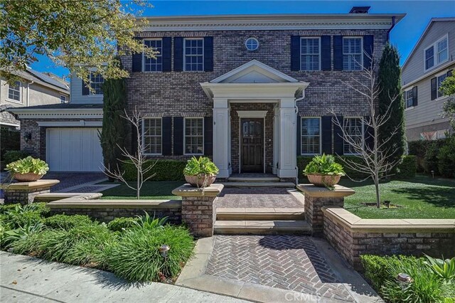 view of front of home with brick siding and an attached garage