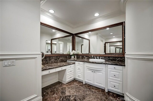 bathroom with marble finish floor, crown molding, vanity, and recessed lighting