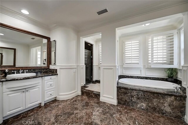 bathroom with marble finish floor, visible vents, a decorative wall, crown molding, and wainscoting