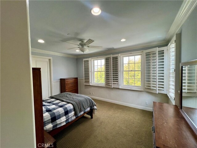 carpeted bedroom featuring a wainscoted wall, visible vents, recessed lighting, and crown molding