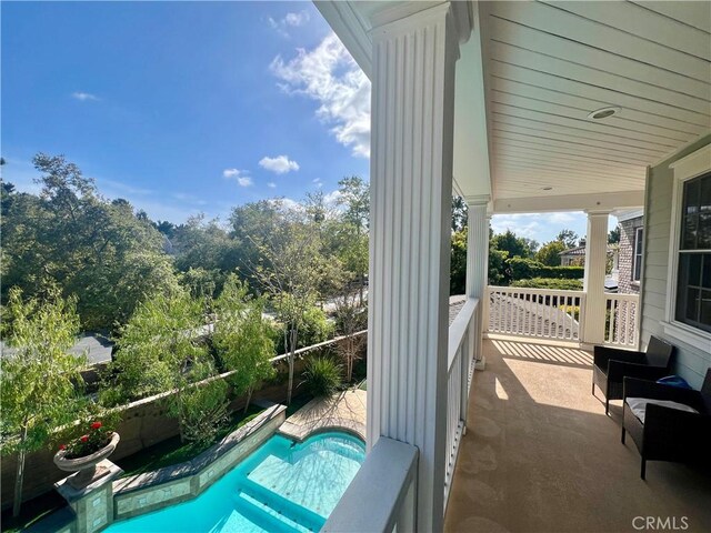 exterior space featuring a fenced in pool and a porch