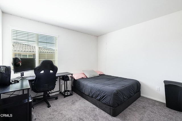 carpeted bedroom featuring baseboards