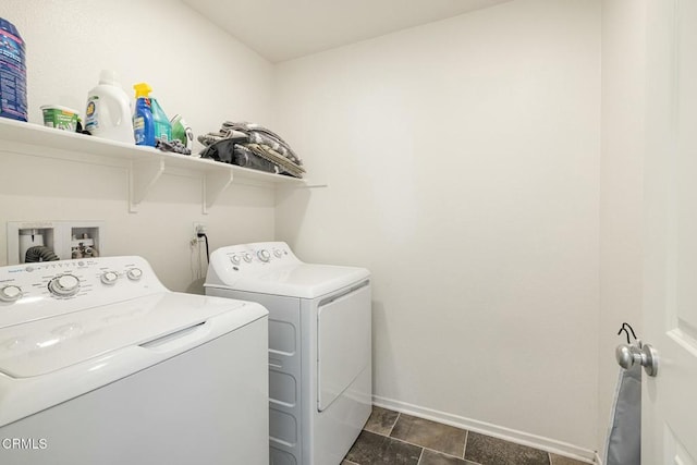 clothes washing area with laundry area, baseboards, and washer and clothes dryer