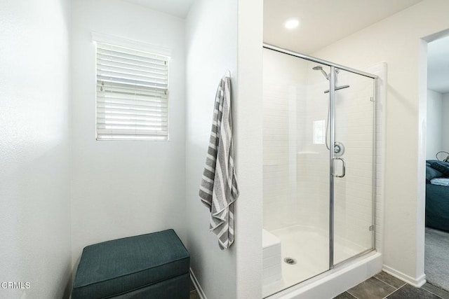 bathroom featuring tile patterned floors, baseboards, and a stall shower