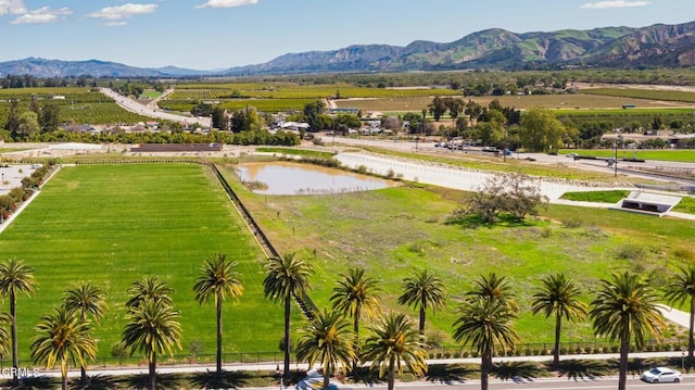 aerial view with a water and mountain view and a rural view