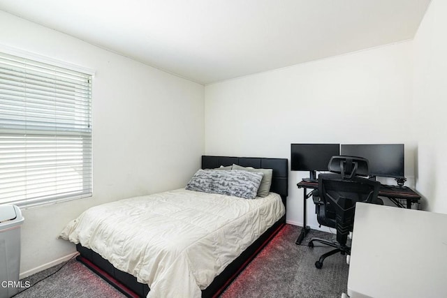 bedroom featuring carpet and baseboards