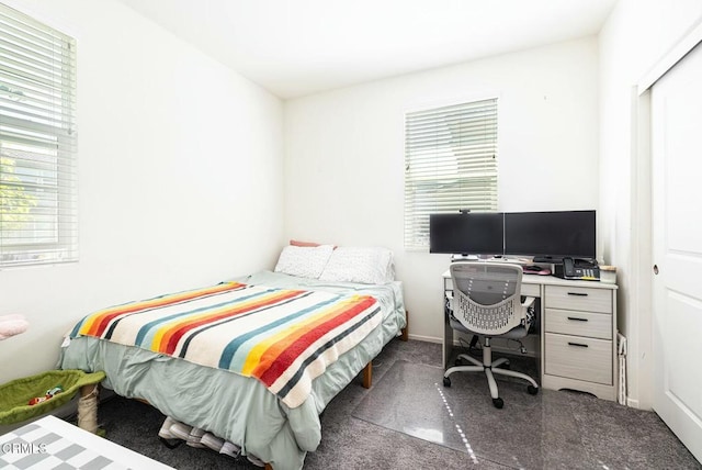 carpeted bedroom featuring multiple windows