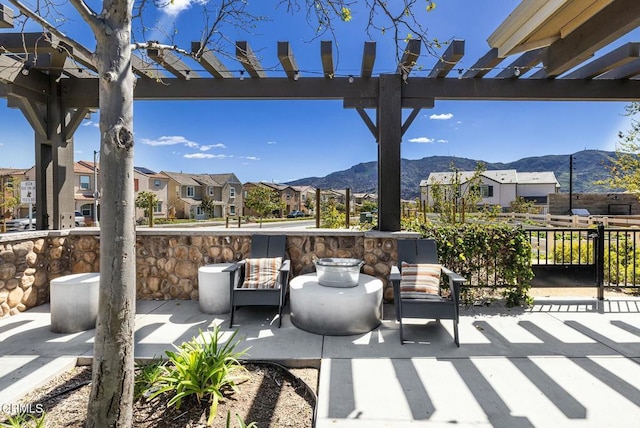 view of patio with a mountain view, a residential view, and a pergola
