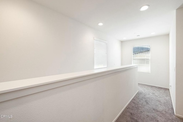 hallway with carpet flooring, recessed lighting, and baseboards