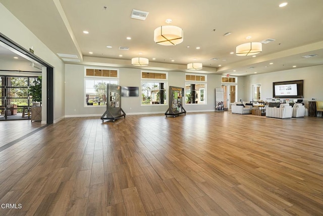workout area featuring visible vents, recessed lighting, baseboards, and wood finished floors
