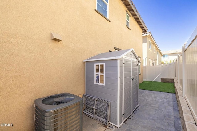 exterior space featuring cooling unit and a fenced backyard