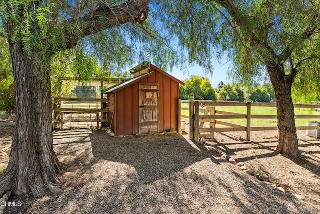 view of outdoor structure featuring an outbuilding and fence