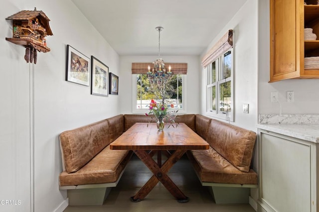 dining area featuring a notable chandelier, baseboards, plenty of natural light, and breakfast area