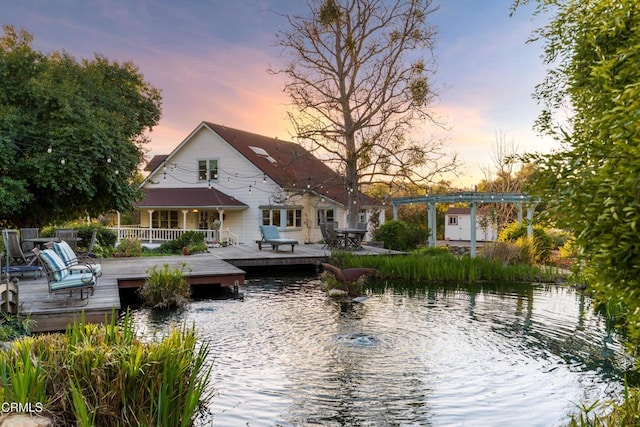 back of house with a deck with water view