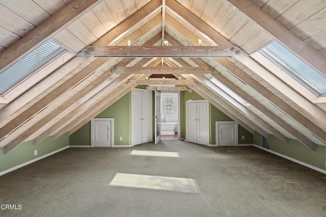 additional living space with carpet, baseboards, and vaulted ceiling