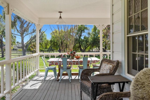 wooden deck featuring outdoor dining area