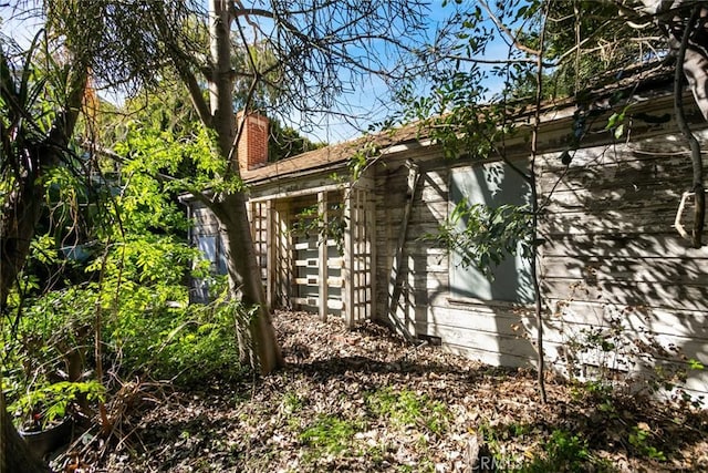 view of side of home with a chimney