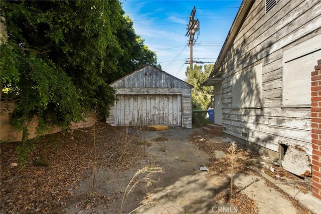 exterior space with an outbuilding and a detached garage
