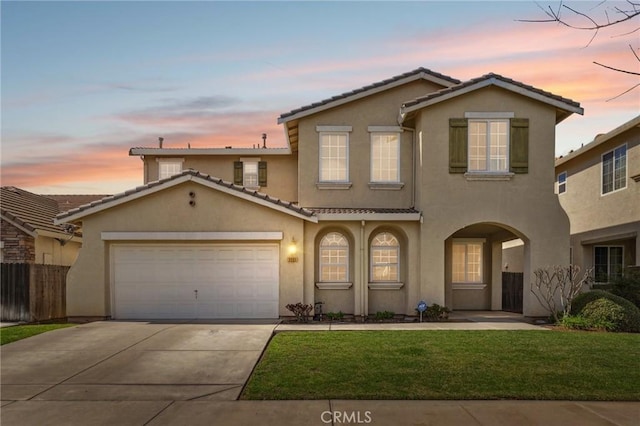 traditional home featuring stucco siding, fence, driveway, and a tiled roof