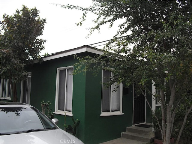 view of side of property with stucco siding