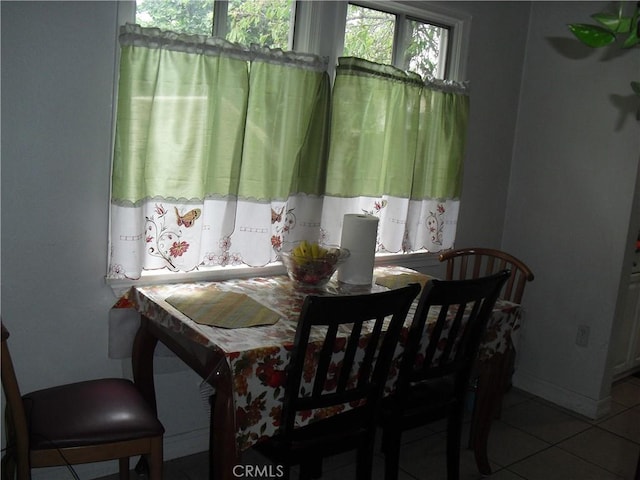 dining area featuring tile patterned floors and baseboards