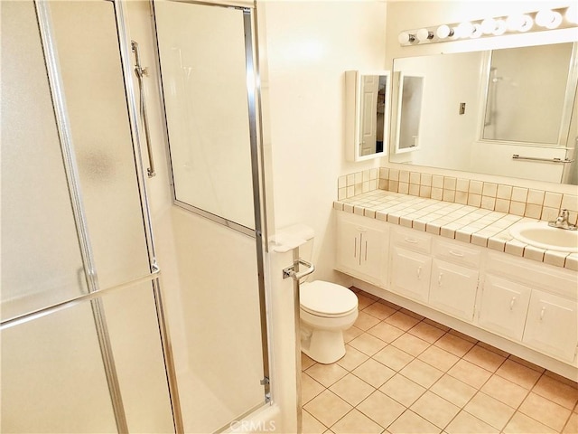 full bathroom with vanity, toilet, a shower stall, and tile patterned flooring