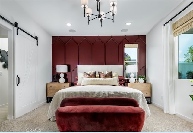 bedroom with a barn door, multiple windows, a chandelier, and carpet flooring