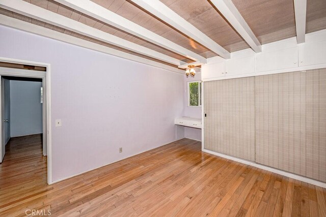 10670 Olive Grove Ave, Sunland, CA 91040 - spare room with beamed ceiling, light wood-style floors, and a chandelier