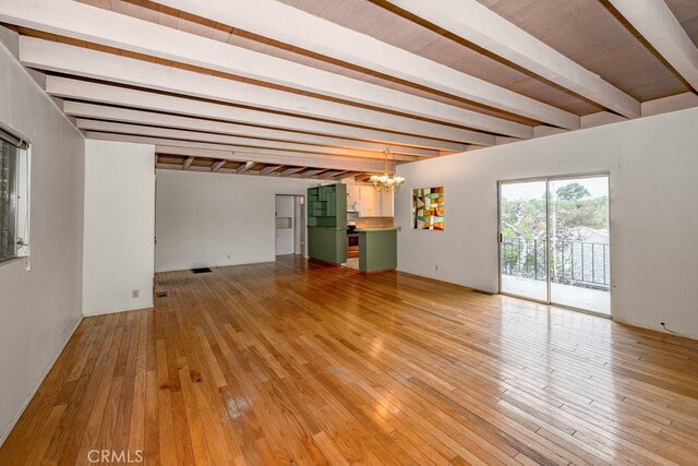 10670 Olive Grove Ave, Sunland, CA 91040 - unfurnished living room featuring a chandelier, beam ceiling, and light wood-style floors