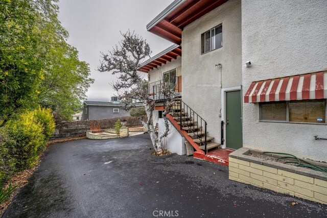 10670 Olive Grove Ave, Sunland, CA 91040 - view of home's exterior featuring stucco siding, stairs, and a patio