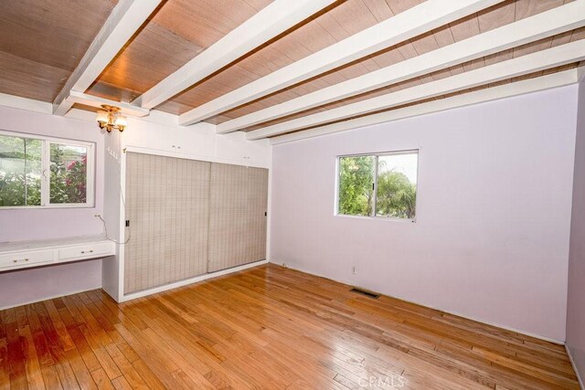 10670 Olive Grove Ave, Sunland, CA 91040 - unfurnished bedroom with beamed ceiling, light wood-type flooring, a chandelier, multiple windows, and wood ceiling