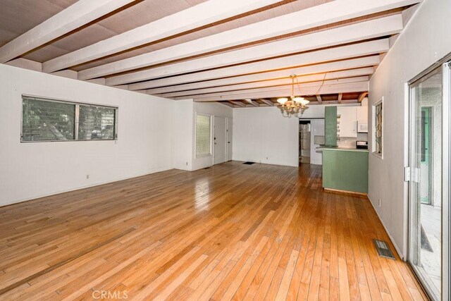 10670 Olive Grove Ave, Sunland, CA 91040 - spare room featuring a chandelier, beam ceiling, and light wood-style floors