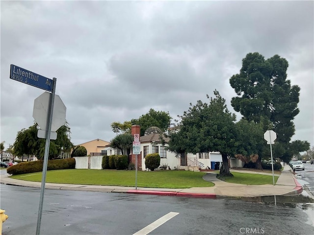 view of street with traffic signs, curbs, and sidewalks